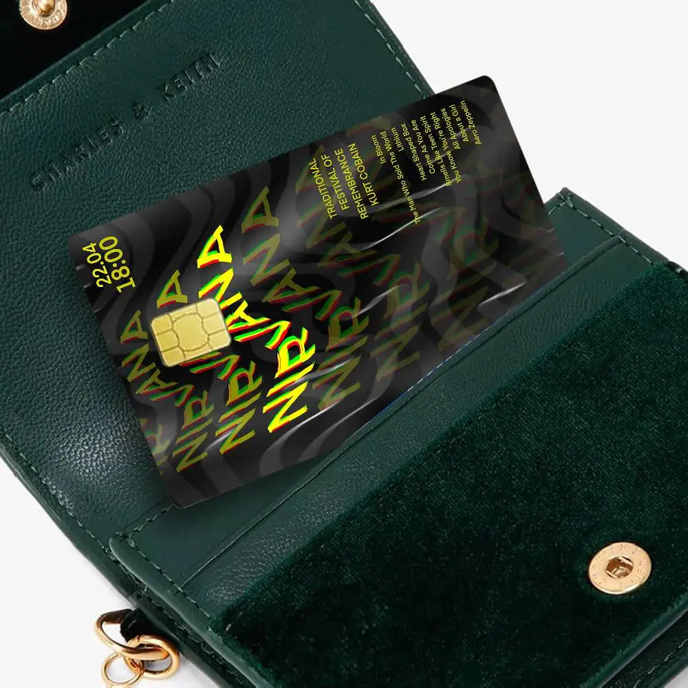 A dark green wallet with a black debit card sticker featuring an anime design.
