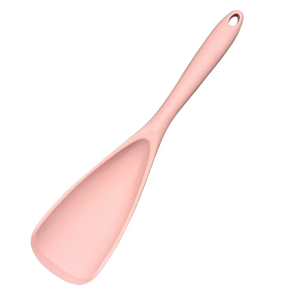A pink heat resistant silicone stirring spoon with a tapered handle.