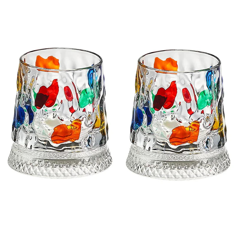 A set of rotating whiskey glasses filled with colorful liquid and garnishes.