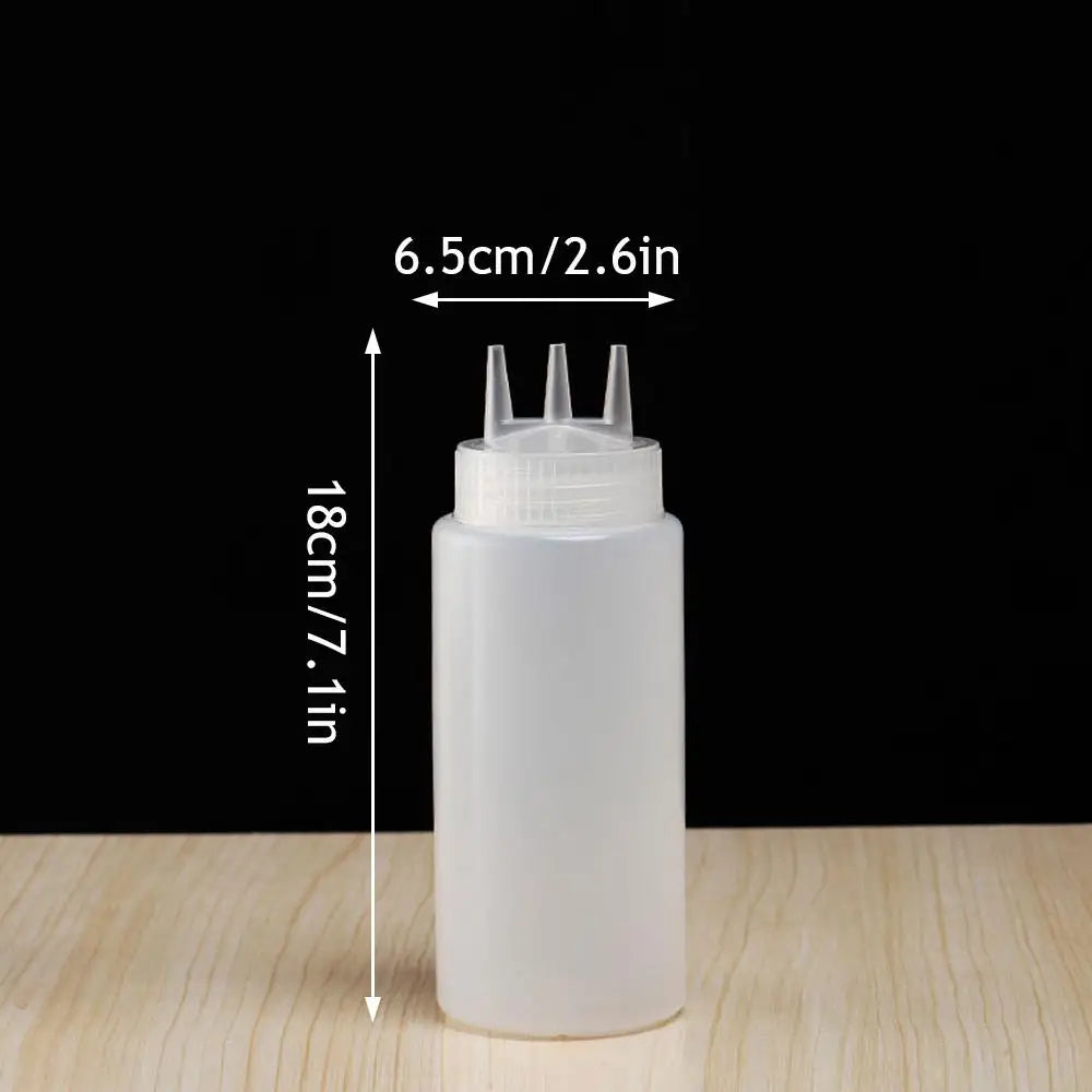 A white multifunctional squeeze bottle dispenser with a narrow neck and multiple dispensing nozzles is shown against a dark b
