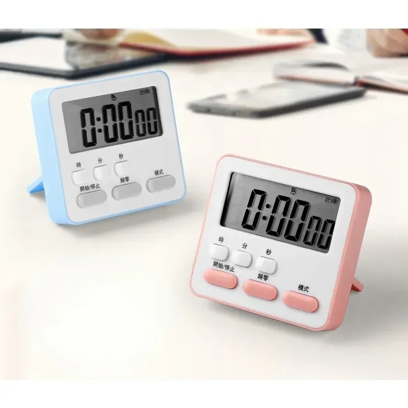 A pink digital kitchen timer with display and buttons is shown on a white surface.