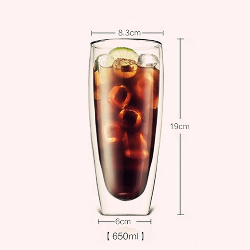 A tall, clear double-wall glass drinking cup filled with iced tea and garnished with citrus slices.