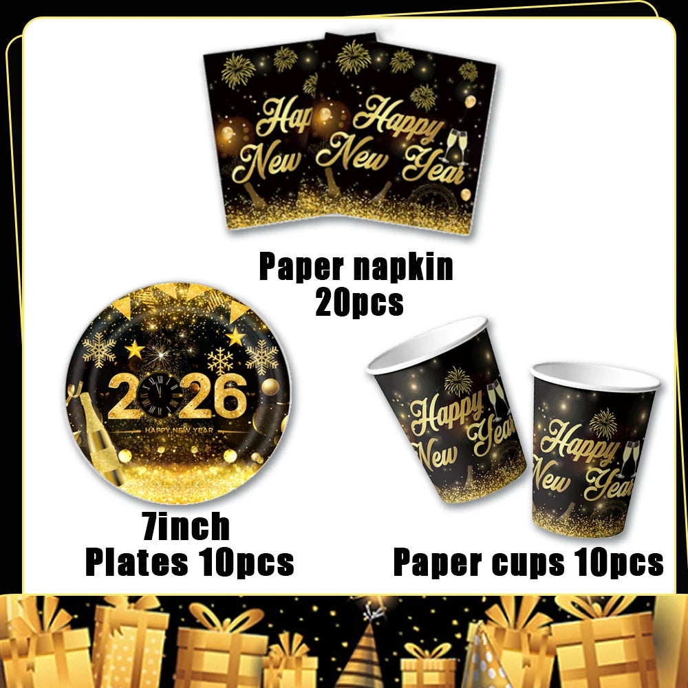 A set of gold and black disposable party tableware including paper napkins, plates, and cups for a New Year celebration.