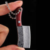 A hand holds a wooden handle and a Damascus pattern pocket mini knife blade.