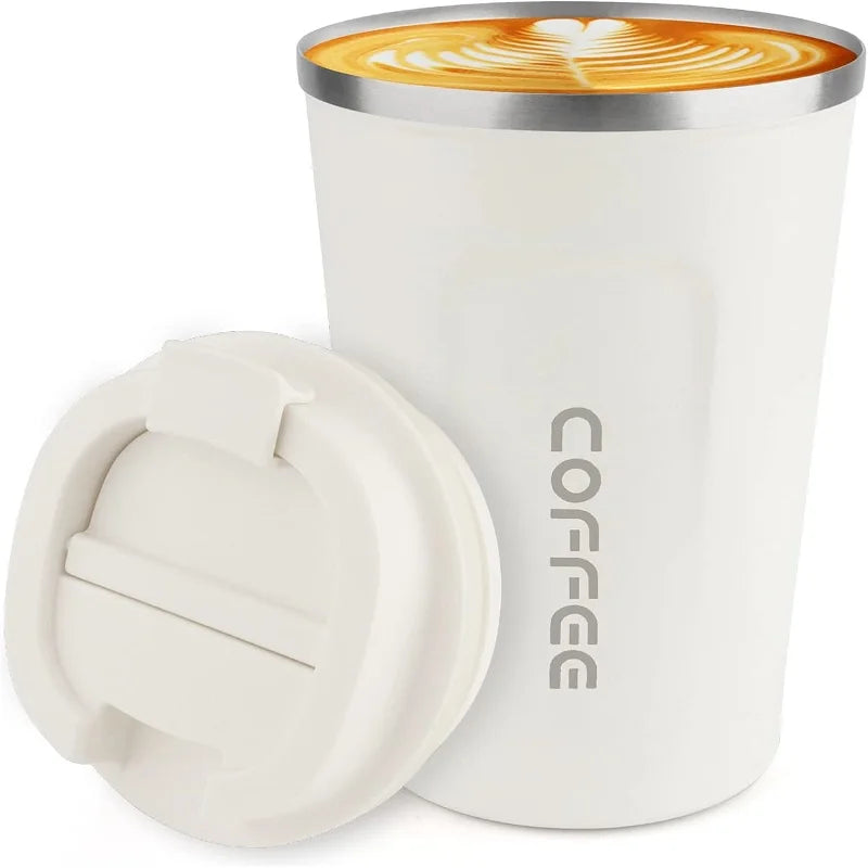 A white double-walled stainless steel travel mug filled with latte art.