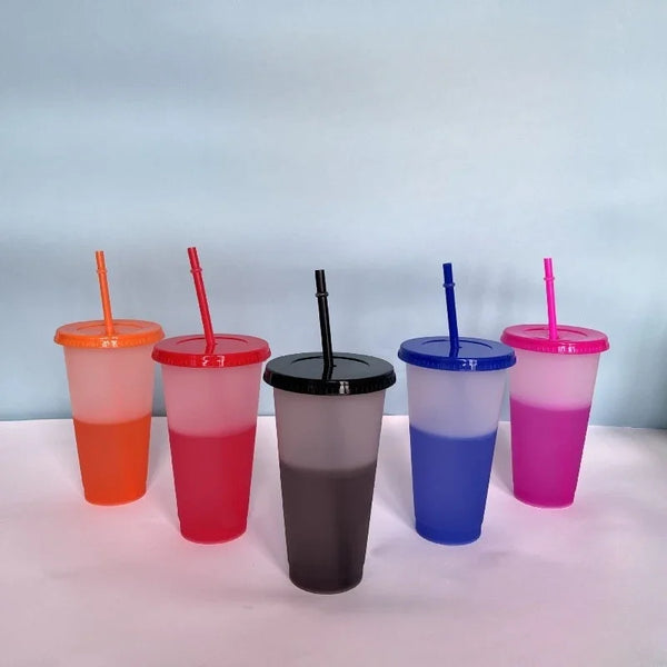 A set of five color-changing reusable tumblers in orange, red, gray, blue, and pink are displayed against a light blue backgr