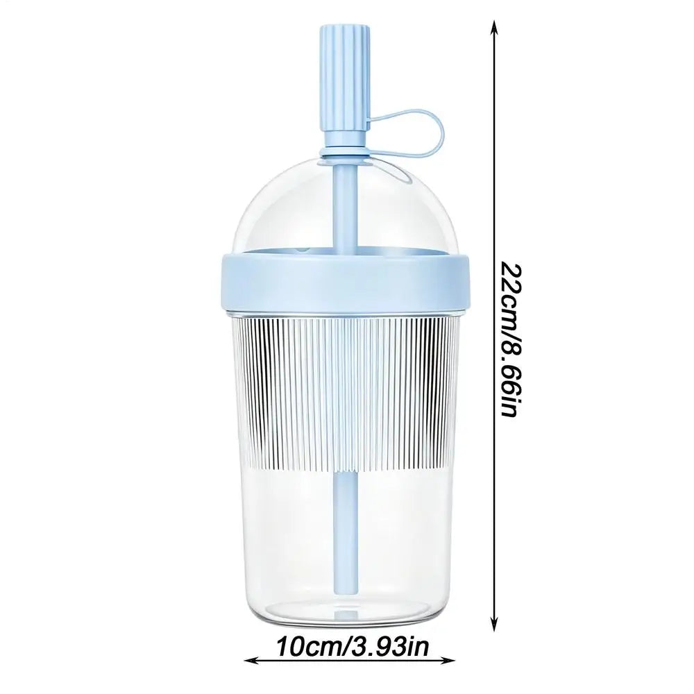 Clear reusable tumbler coffee cup with a light blue straw lid and measuring markings.
