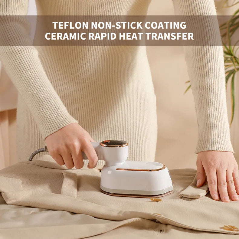 A person is using a white handheld garment steamer with a metallic nozzle to steam fabric on a beige cloth.