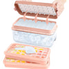 A stackable silicone ice cube tray set with a storage bin and multiple trays is shown being held by hands.