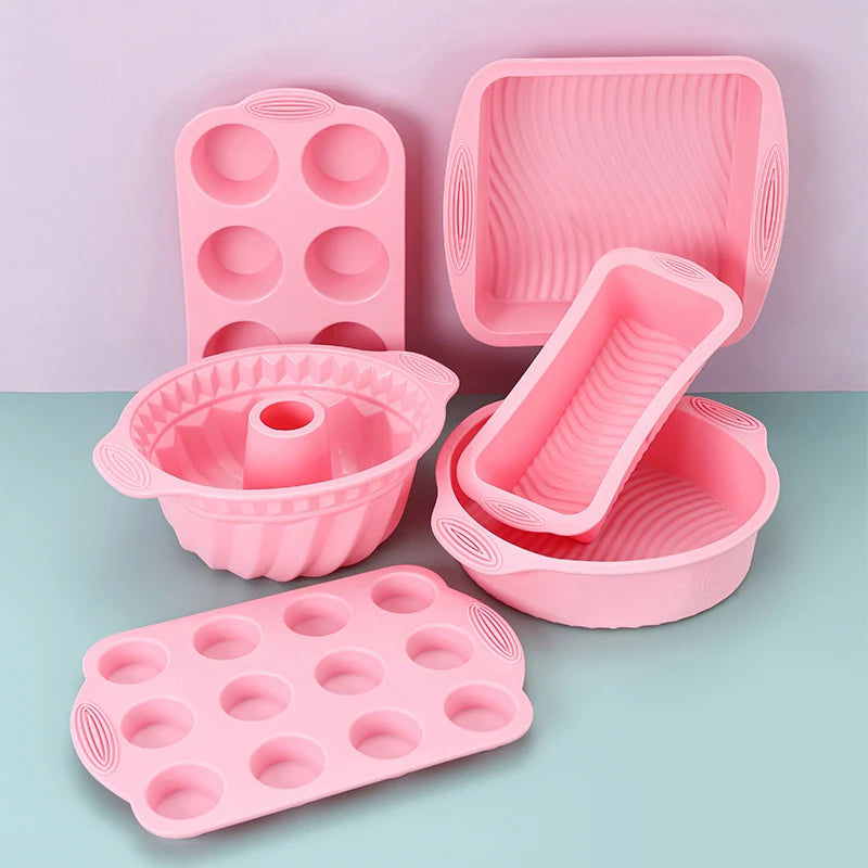 A pink nonstick silicone baking set featuring various molds and cups for cakes and desserts.