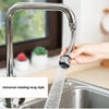 A hand is operating a universal rotating long style kitchen faucet, spraying water into a stainless steel sink.