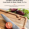 A hand is shown using a sturdy Damascus steel Japanese kitchen knife on a wooden cutting board with fresh tomatoes and herbs.