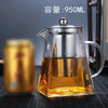 A clear glass teapot filled with amber tea, featuring a stainless steel infuser and a lid.