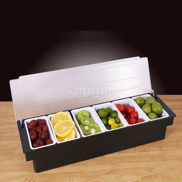 Schwarzer Edelstahlgewürzhalter mit sechs Fächern, gefüllt mit frischem Obst und Zitrusfrüchten.