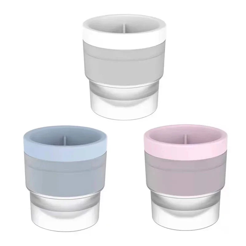 A set of stackable food-grade ice molds for cocktails in light gray and pink colors.