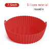 A red silicone reusable baking or cooking pan with fluted sides.
