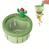 A green automatic cactus sink drain strainer with a cactus top is shown draining orange and green food scraps.
