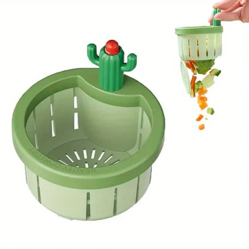 A green automatic cactus sink drain strainer with a cactus top is shown draining orange and green food scraps.