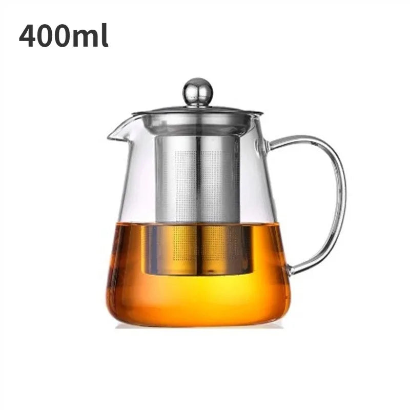 A clear borosilicate glass teapot filled with amber-colored tea, featuring a stainless steel infuser and lid.