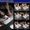 A set of three stainless steel double-sided cutting boards used for preparing fruits, vegetables, meat, and pasta.