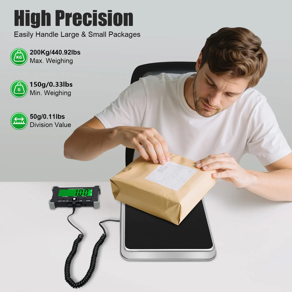 A man is using a high precision digital shipping scale to weigh small packages on a table.