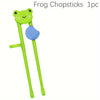 A bright green frog-shaped training chopstick with a blue grip.