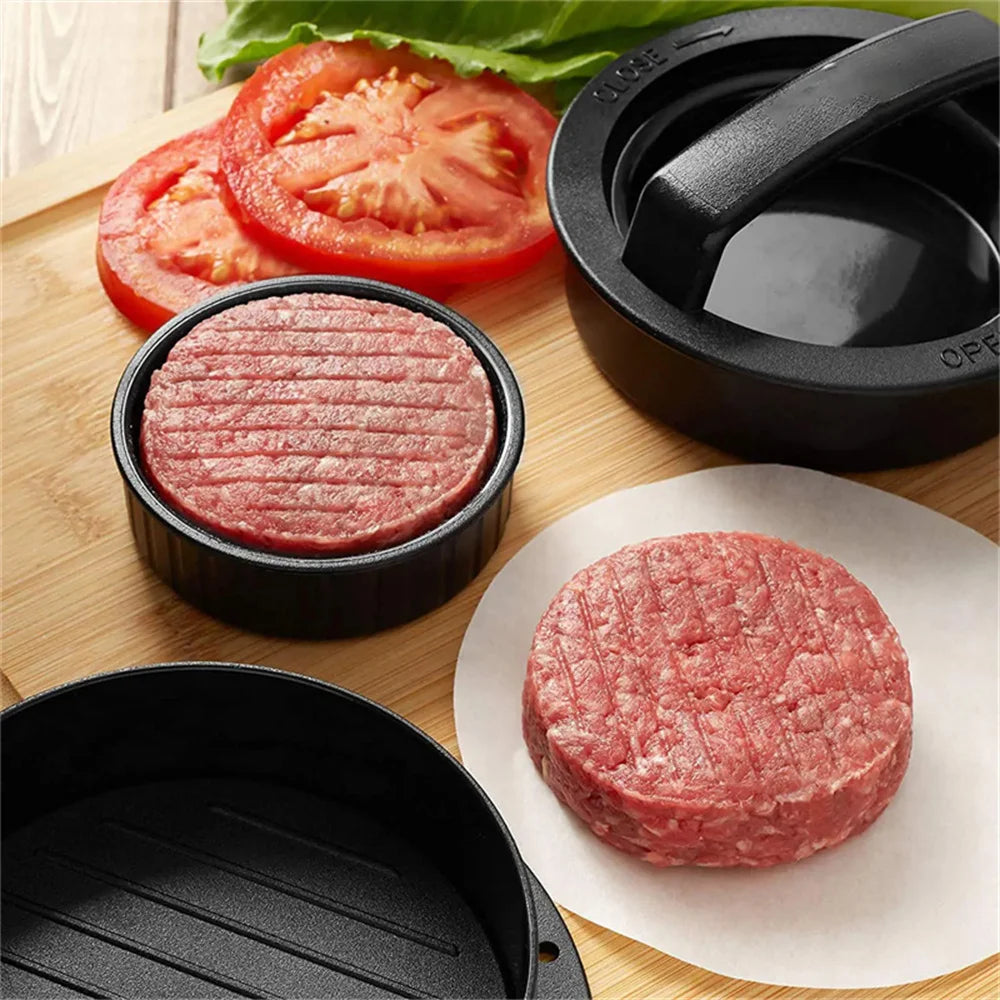 A set of black hamburger meat presses and a raw ground beef patty are displayed on a wooden cutting board.