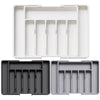 A set of adjustable plastic flatware organizer trays in black and gray.