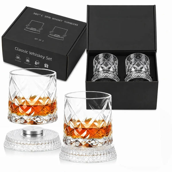 A set of two clear crystal whiskey tumblers and a presentation box for 360° spin whiskey glasses.