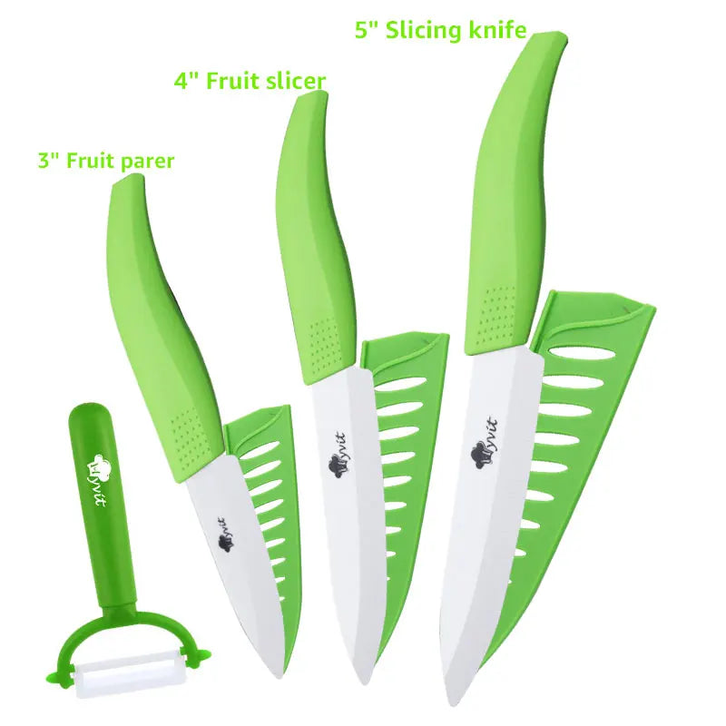 A set of five green and white ceramic slicing knives, including a 5 inch slicing knife, 4 inch fruit slicer, and 3 inch fruit