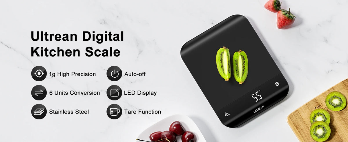 A black digital kitchen scale is shown on a white marble surface next to fresh strawberries and kiwi fruit slices.