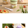 Three reusable and leakproof portable food containers in pink, green, and yellow holding fruit and yogurt.