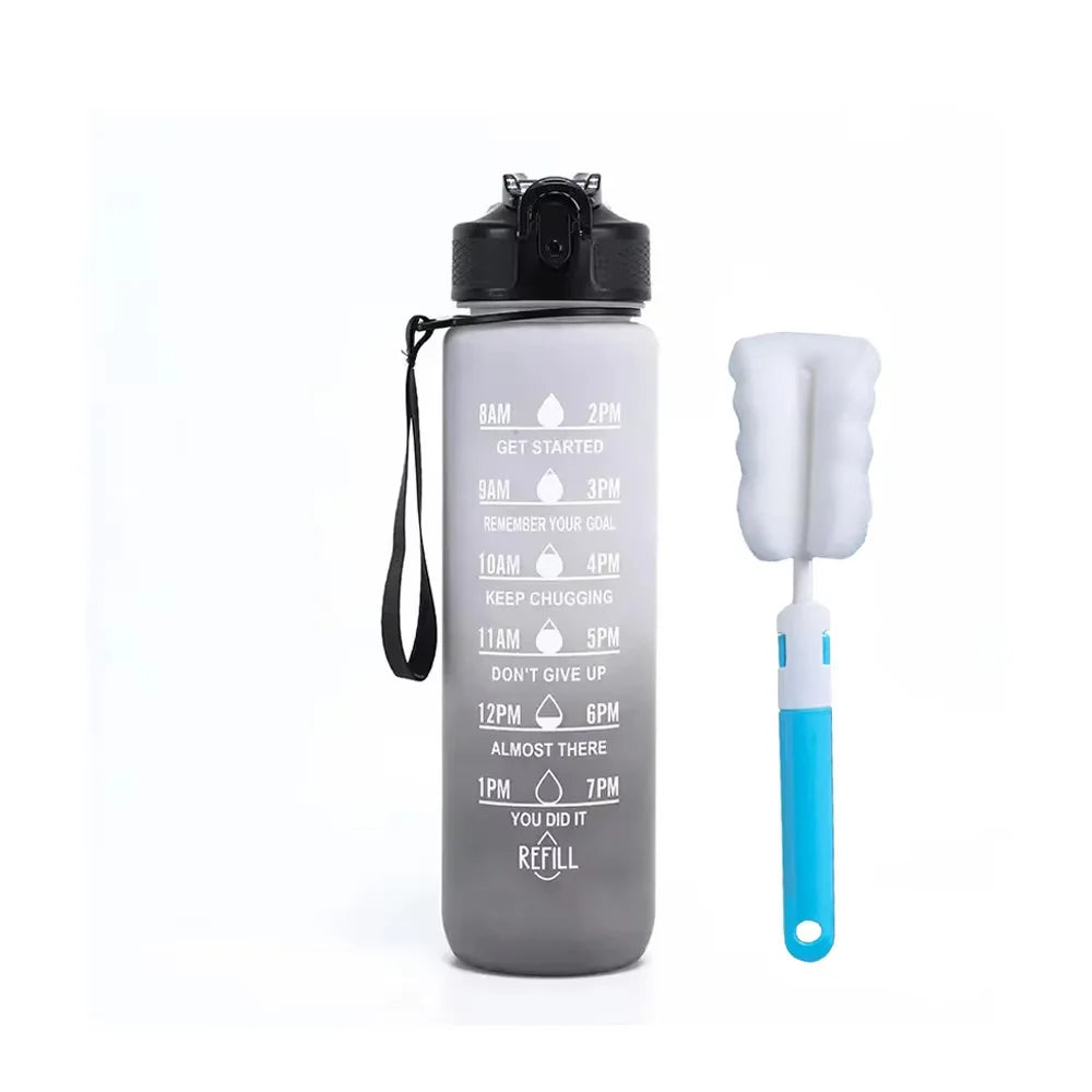 A gray automatic electric water dispenser pump bottle with a white silicone cleaning brush.