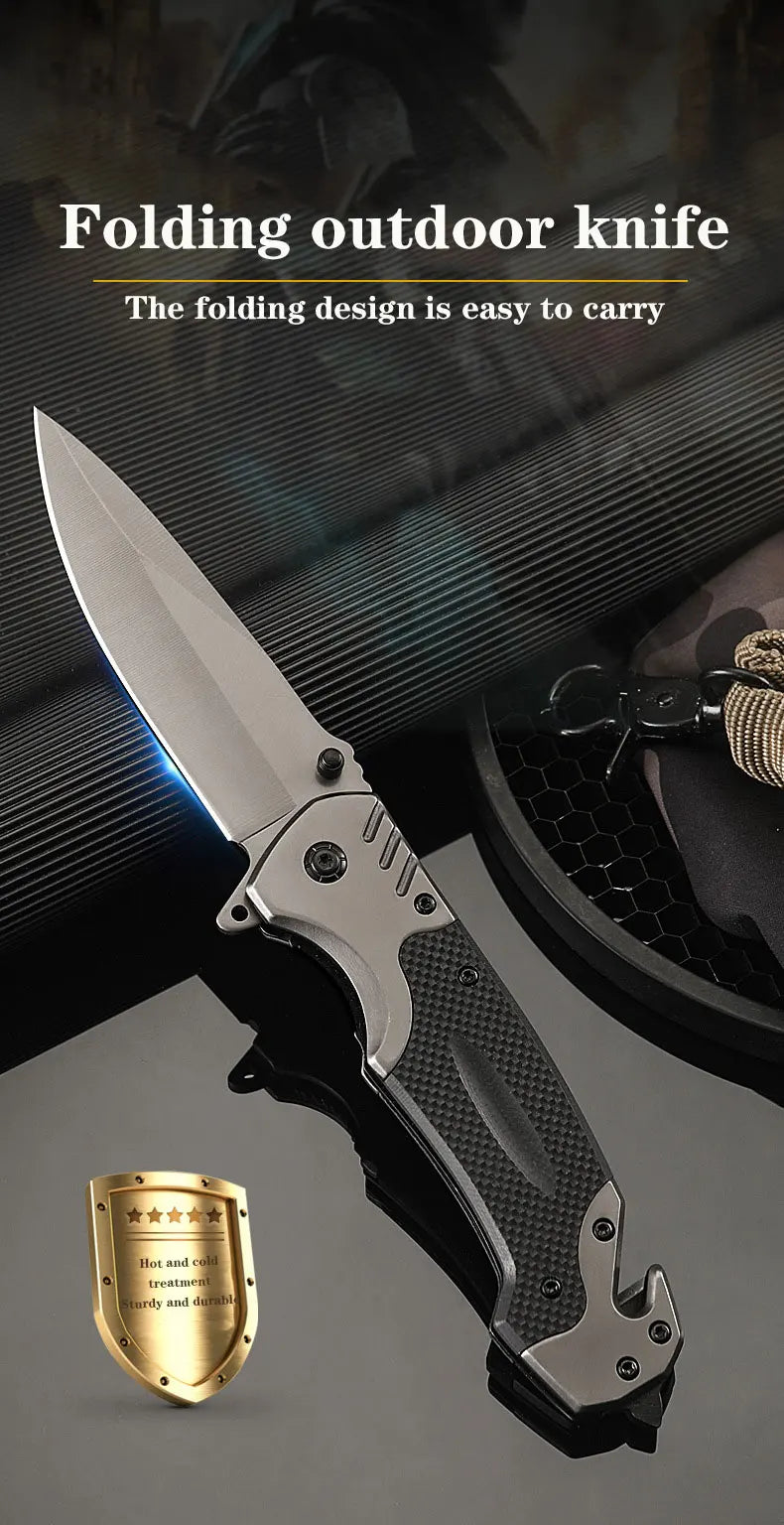 A silver folding outdoor knife with a black textured handle and a gold heat treatment mark is displayed on a dark background.