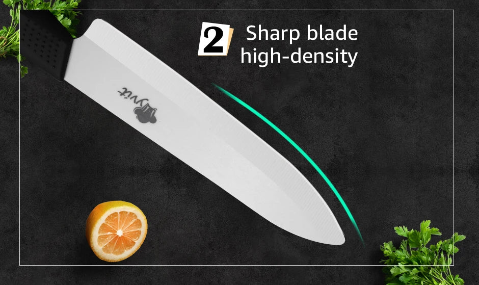 A white chef knife is shown against a dark background with a slice of orange and green herbs.