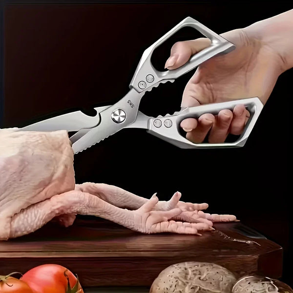 Eine Hand benutzt schwere Edelstahl-Küchenschere, um einen rohen Hähnchenfuß zu schneiden.