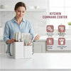 A woman is shown using a white kitchen command center storage organizer filled with various knives and silicone tools.