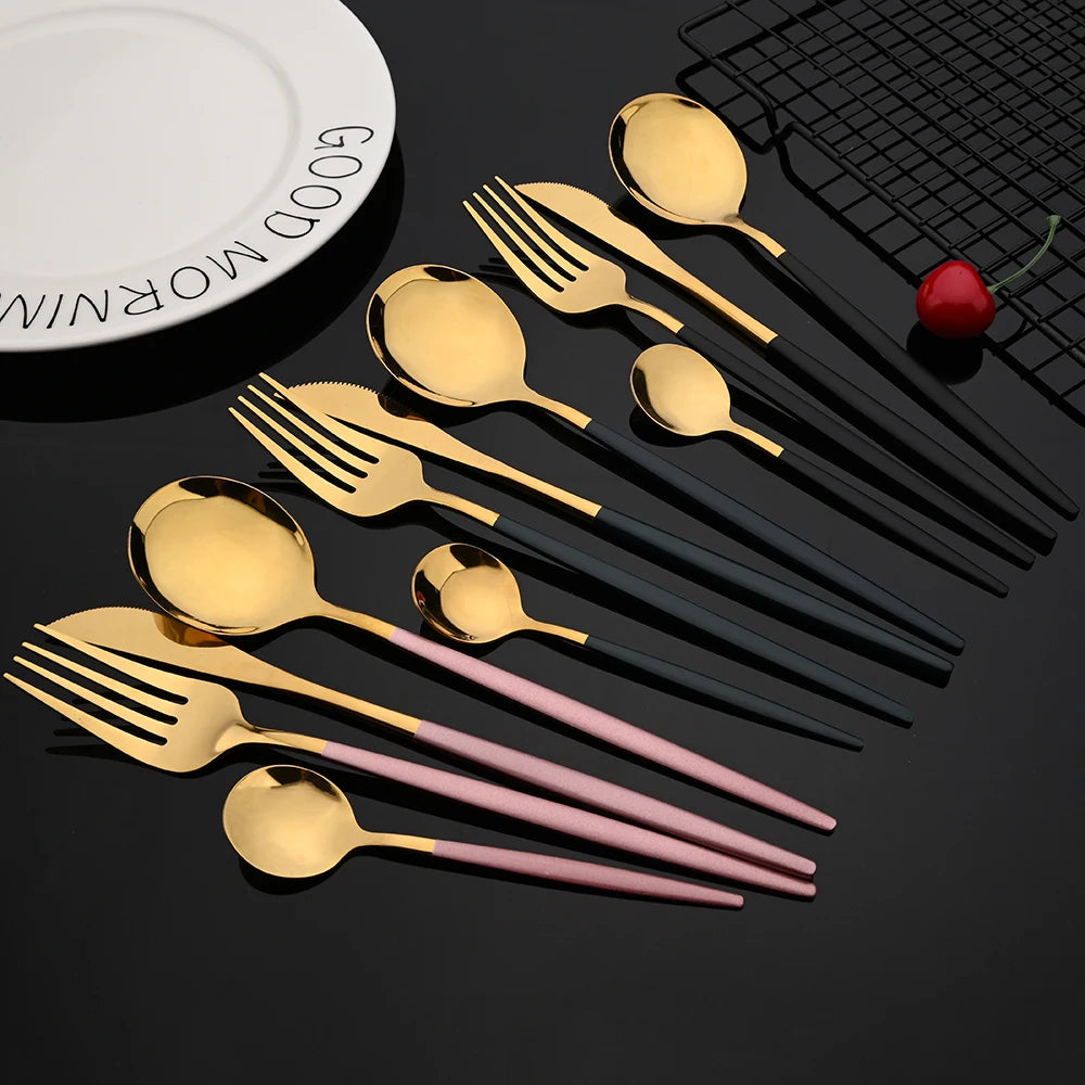 A set of gold and rose gold stainless steel cutlery including spoons and forks displayed on a dark surface.