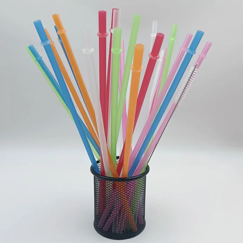 A collection of colorful reusable plastic straws and cleaning brushes in various shades of blue, orange, pink, and green stor