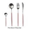 A set of four pink silver cutlery pieces including a spoon and fork
