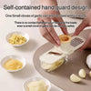Hands demonstrate a self-contained hand guard design for safely cutting garlic cloves on a small grinder.