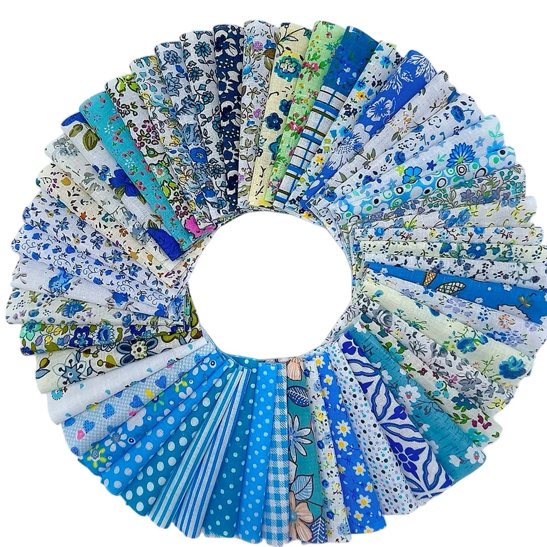 A circular display of square printed cotton fabric packs in various blues, greens, and whites.