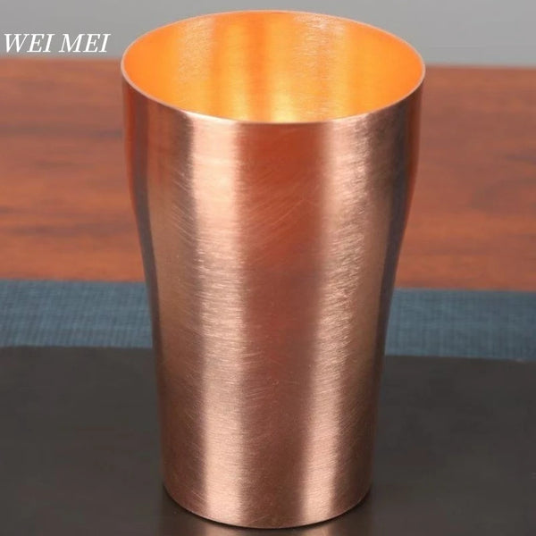 A handcrafted vintage copper coffee mug with a glossy finish, shown against a dark background.