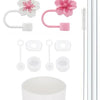 A set of reusable silicone straw covers and cleaning brushes with pink and white components.