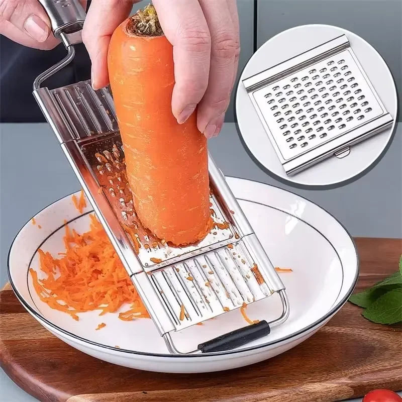 A hand is using a stainless steel manual vegetable grater and slicer to grate a carrot on a plate.