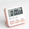A pink digital kitchen timer with a display showing 0:00:00 and buttons for start, stop, clear, and mode.
