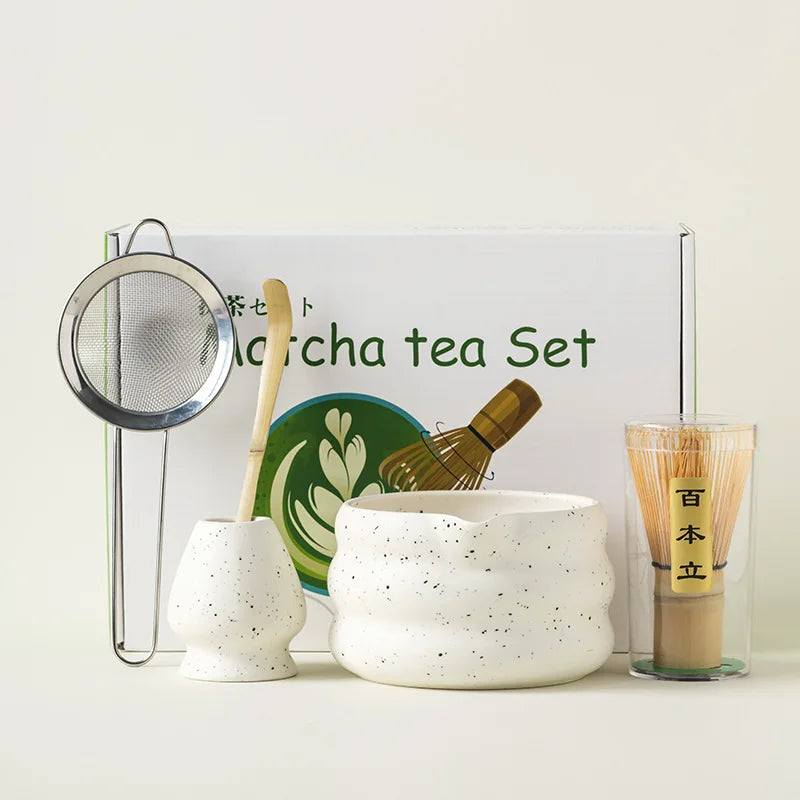 A traditional Japanese matcha tea set featuring a white ceramic bowl and bamboo whisk displayed on a white background.