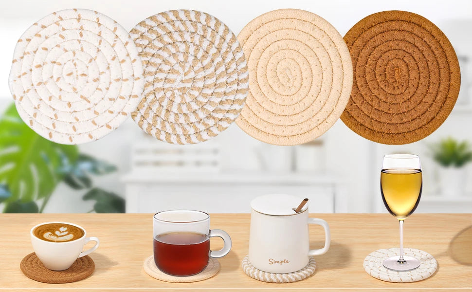 A set of eight round, absorbent cotton drink coasters in various natural earth tones are displayed on a wooden surface.