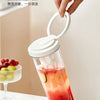 A hand is holding a glass jar of iced tea or cold brew coffee, showing the design for a travel mug.