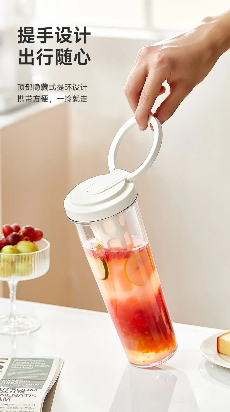 A hand is holding a glass jar of iced tea or cold brew coffee, showing the design for a travel mug.